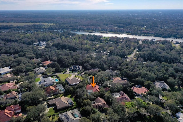 aerial view featuring a water view, a residential view, and a view of trees