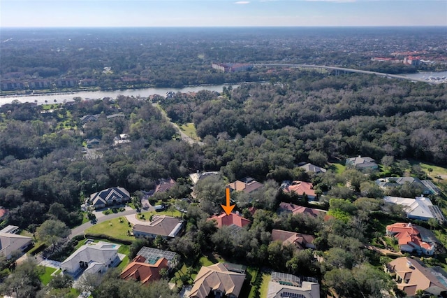 birds eye view of property with a water view, a wooded view, and a residential view