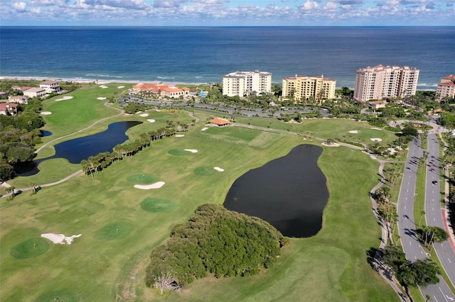 bird's eye view with view of golf course, a water view, and a city view