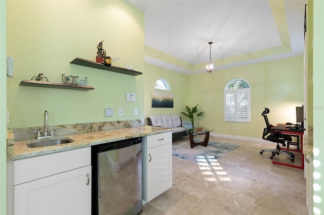 kitchen featuring a raised ceiling, dishwasher, white cabinetry, open shelves, and a sink