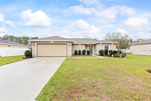 single story home with a garage, fence, concrete driveway, stucco siding, and a front yard