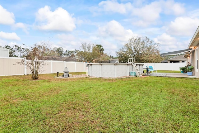 view of yard with a fenced backyard, a fenced in pool, and a patio