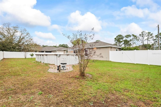 view of yard featuring a fenced backyard and a swimming pool