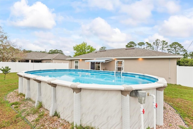 view of swimming pool with a fenced backyard, a fenced in pool, and a yard