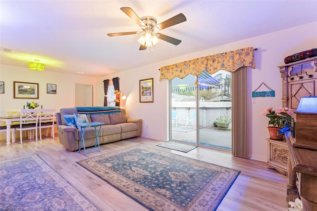 living area featuring ceiling fan and wood finished floors