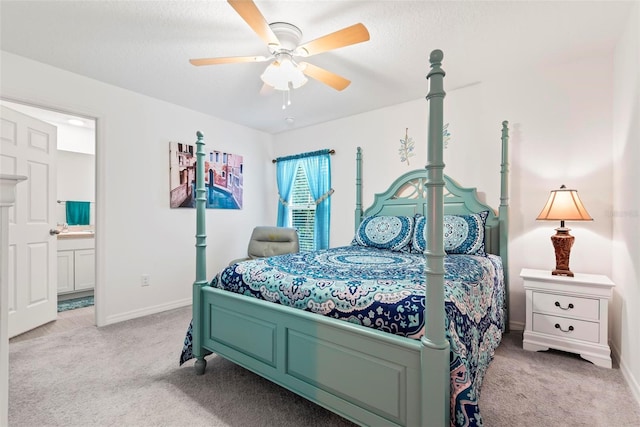 bedroom featuring ensuite bathroom, carpet flooring, a ceiling fan, and baseboards