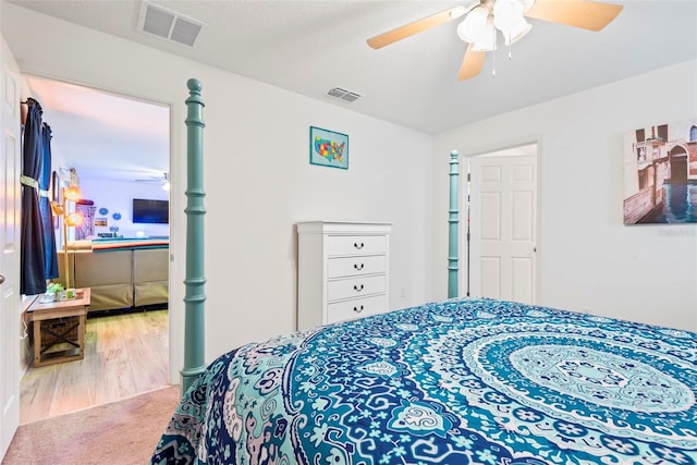 bedroom featuring carpet floors, ceiling fan, and visible vents