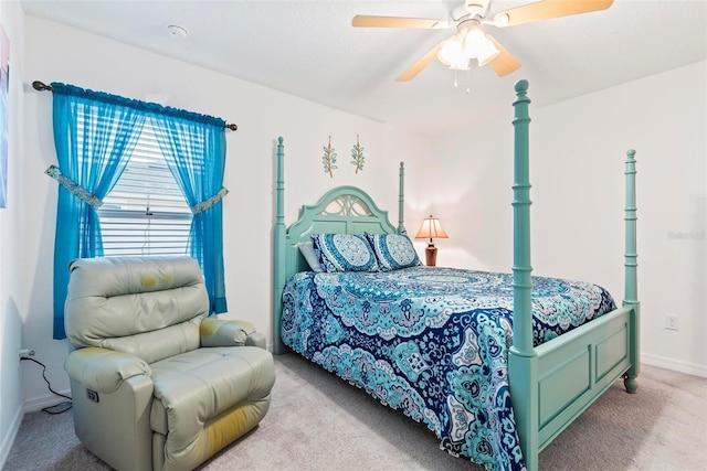 bedroom with ceiling fan, baseboards, and carpet flooring