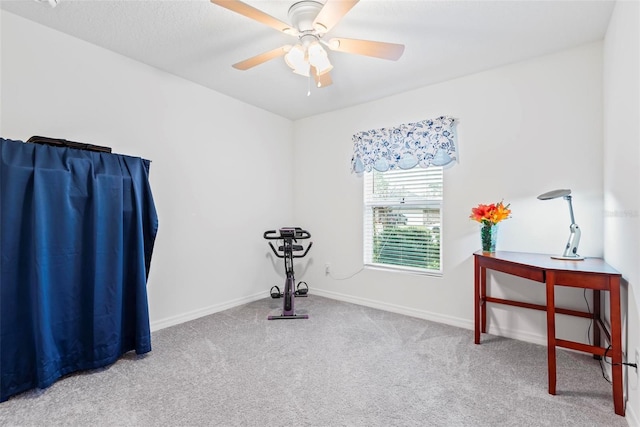 exercise area with ceiling fan, carpet floors, and baseboards