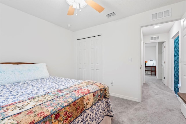 carpeted bedroom featuring a closet, visible vents, and baseboards