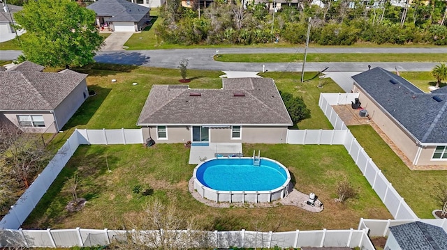 view of pool featuring a lawn, a residential view, a fenced backyard, and a fenced in pool