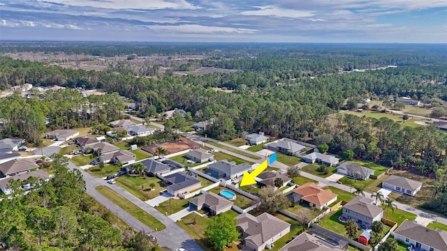 birds eye view of property featuring a residential view and a wooded view