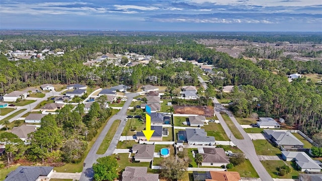 drone / aerial view with a forest view and a residential view