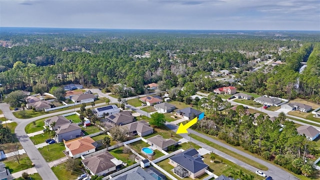 drone / aerial view featuring a forest view and a residential view