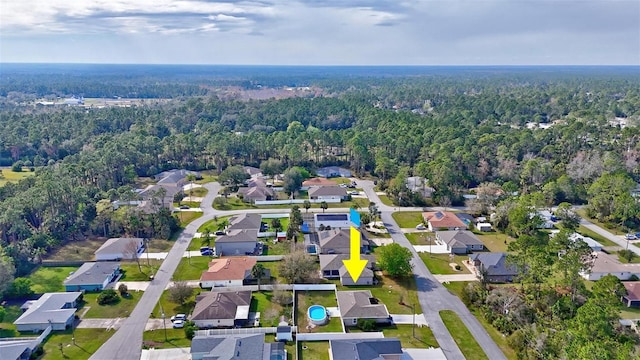 birds eye view of property featuring a wooded view and a residential view