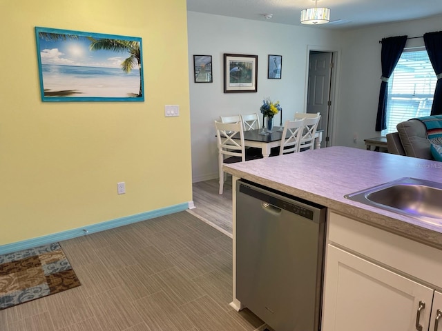 8 Smoke Tree Pl, Palm Coast, FL 32164 - kitchen featuring dishwasher, white cabinets, baseboards, a sink, and light countertops