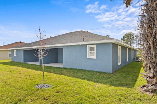 back of property featuring a patio area, a lawn, central AC, and stucco siding