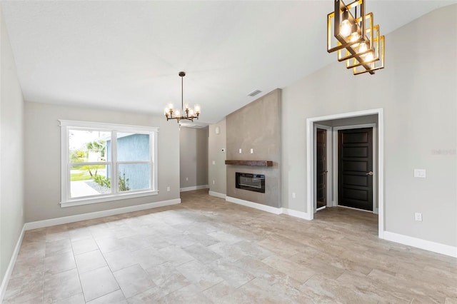 unfurnished living room with an inviting chandelier, baseboards, visible vents, and a large fireplace