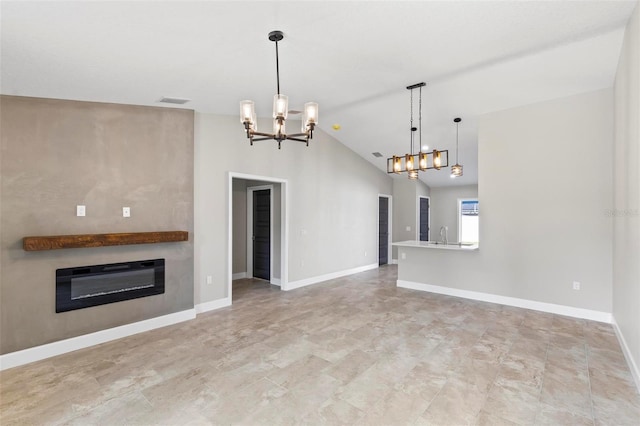 unfurnished living room featuring heating unit, baseboards, vaulted ceiling, and a glass covered fireplace