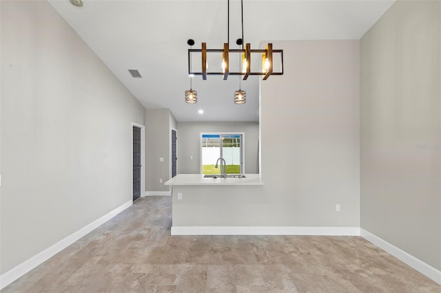 spare room featuring visible vents, a sink, and baseboards