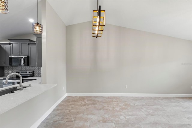 dining room featuring lofted ceiling and baseboards