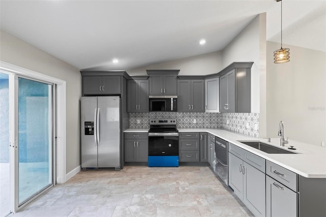 kitchen with backsplash, stainless steel appliances, a sink, and gray cabinetry