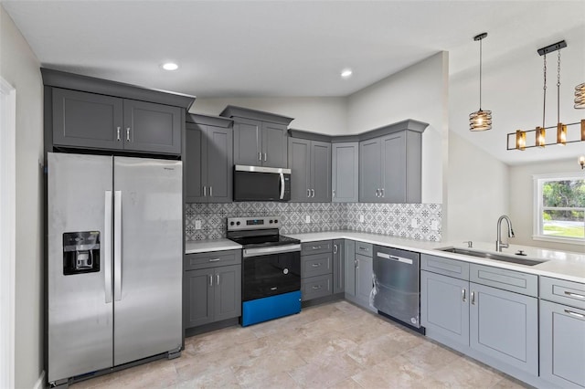 kitchen with stainless steel appliances, light countertops, backsplash, gray cabinetry, and a sink