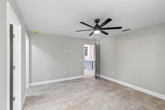 unfurnished bedroom with visible vents, connected bathroom, ceiling fan, a textured ceiling, and baseboards