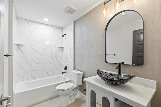 full bathroom featuring toilet, bathing tub / shower combination, vanity, and visible vents