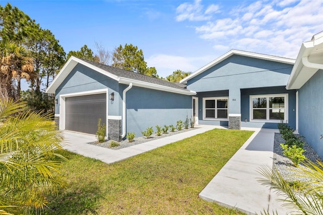 exterior space featuring a yard, an attached garage, and stucco siding