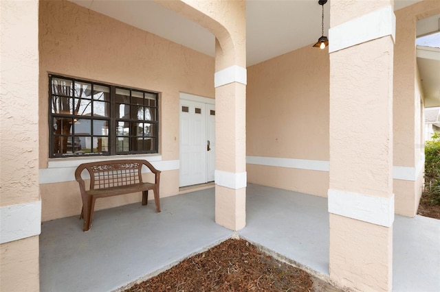 doorway to property with stucco siding