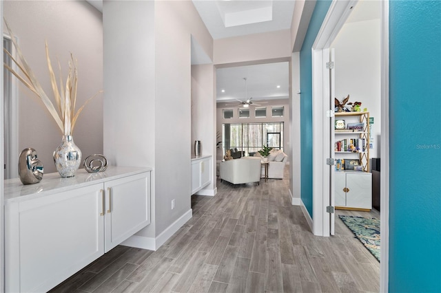 hallway with light wood finished floors and baseboards