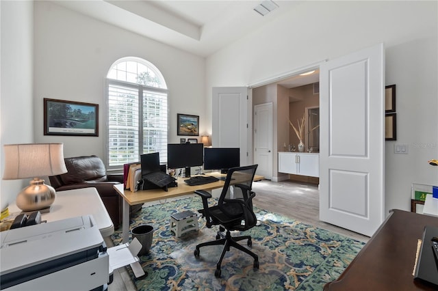 office space with wood finished floors and visible vents