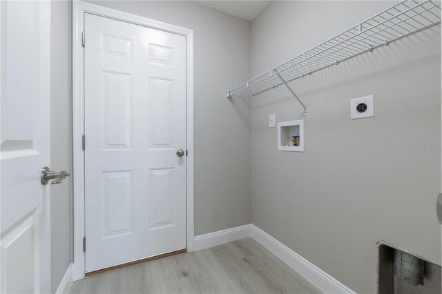 laundry room featuring hookup for a washing machine, light wood-style flooring, hookup for an electric dryer, laundry area, and baseboards