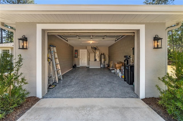 garage with driveway, electric panel, and water heater