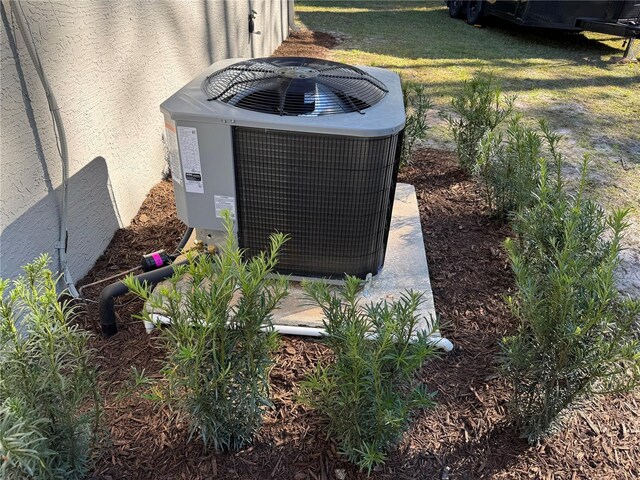 exterior details with central AC and stucco siding