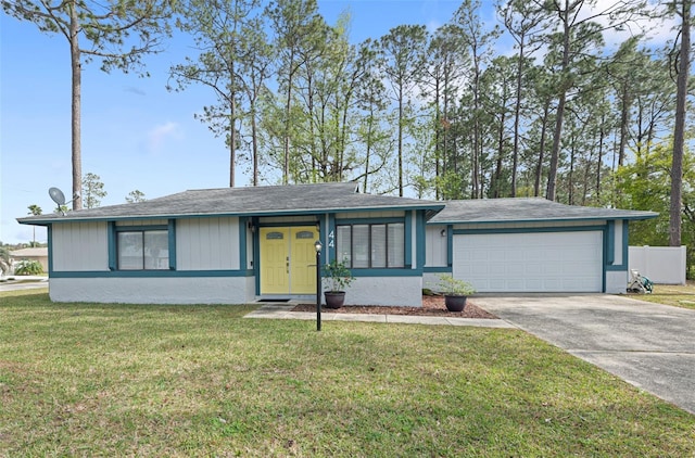 view of front of property with concrete driveway, an attached garage, and a front lawn