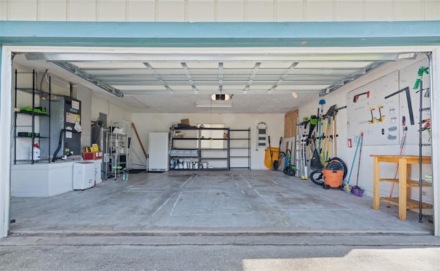 garage featuring a garage door opener and a workshop area