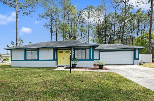 view of front facade with a garage, concrete driveway, a front yard, and fence