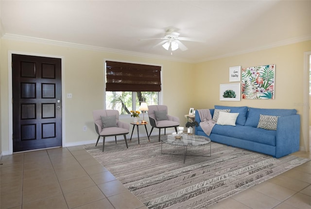 tiled living area with a ceiling fan, crown molding, and baseboards