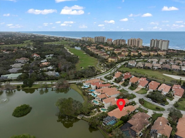 birds eye view of property with a water view