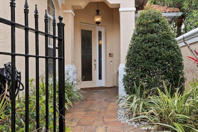 doorway to property featuring stucco siding