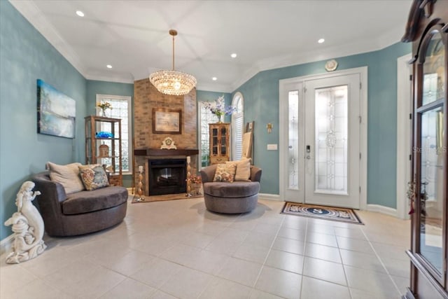 entrance foyer featuring crown molding, a brick fireplace, baseboards, and tile patterned floors