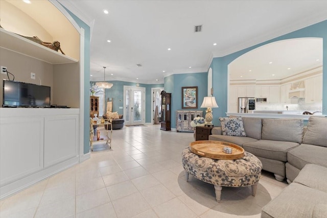 living area featuring light tile patterned floors, ornamental molding, and recessed lighting