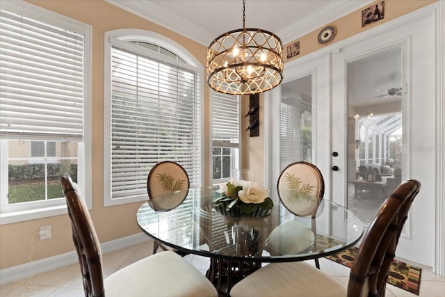 dining area featuring light tile patterned flooring, baseboards, crown molding, and an inviting chandelier