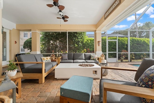 sunroom with a ceiling fan