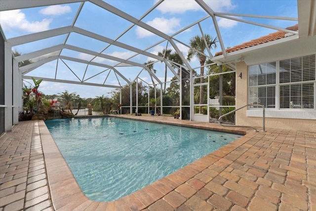 pool featuring a patio area and glass enclosure