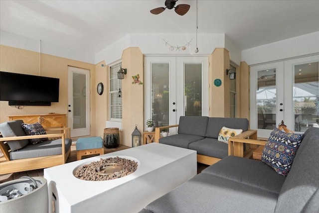 living room with french doors and a ceiling fan