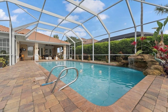 pool with a lanai and a patio area