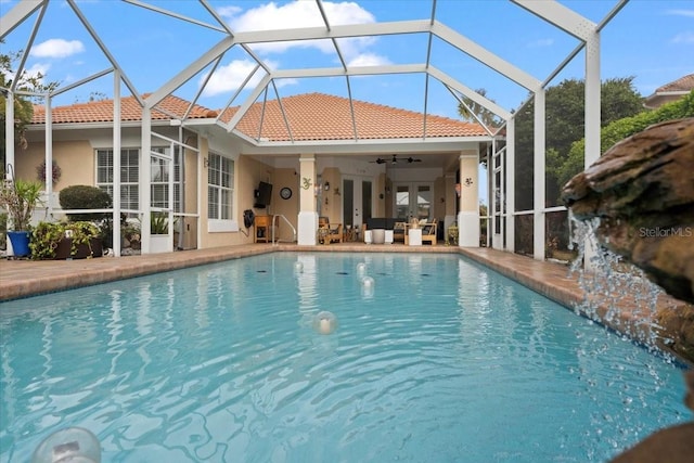 pool featuring a patio area, french doors, a lanai, and ceiling fan